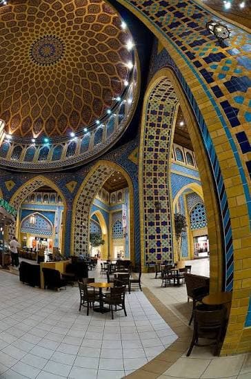 Beautiful Persian-inspired architecture inside Ibn Battuta Mall Dubai, featuring blue mosaic tiles, decorative arches and intricate patterns.