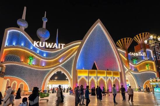 The Kuwait Pavilion at Global Village Dubai, showcasing traditional architectural influences and colorful lighting.