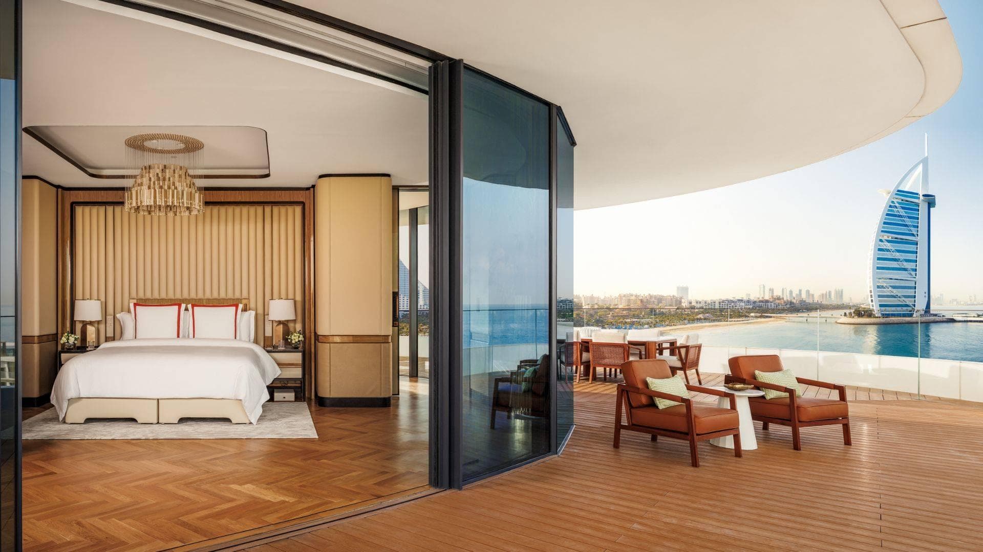 A hotel showroom featuring a bedroom and an outdoor water view, perfect for sunbathing.