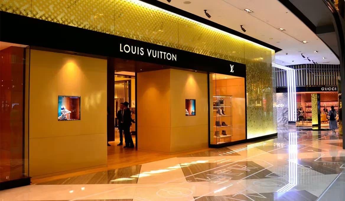 Louis Vuitton store entrance in Fashion Avenue at The Dubai Mall with Gucci store visible nearby