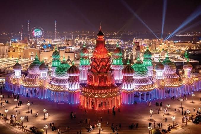 A breathtaking nighttime view of Global Village Dubai, with illuminated pavilions, colorful architecture and lively attractions.