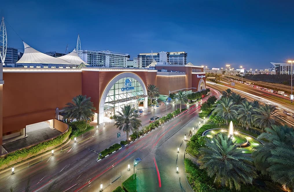 The wide entrance of the Carrefour hypermarket inside City Centre Deira, featuring the blue and red Carrefour logo and people walking through the spacious shopping area.