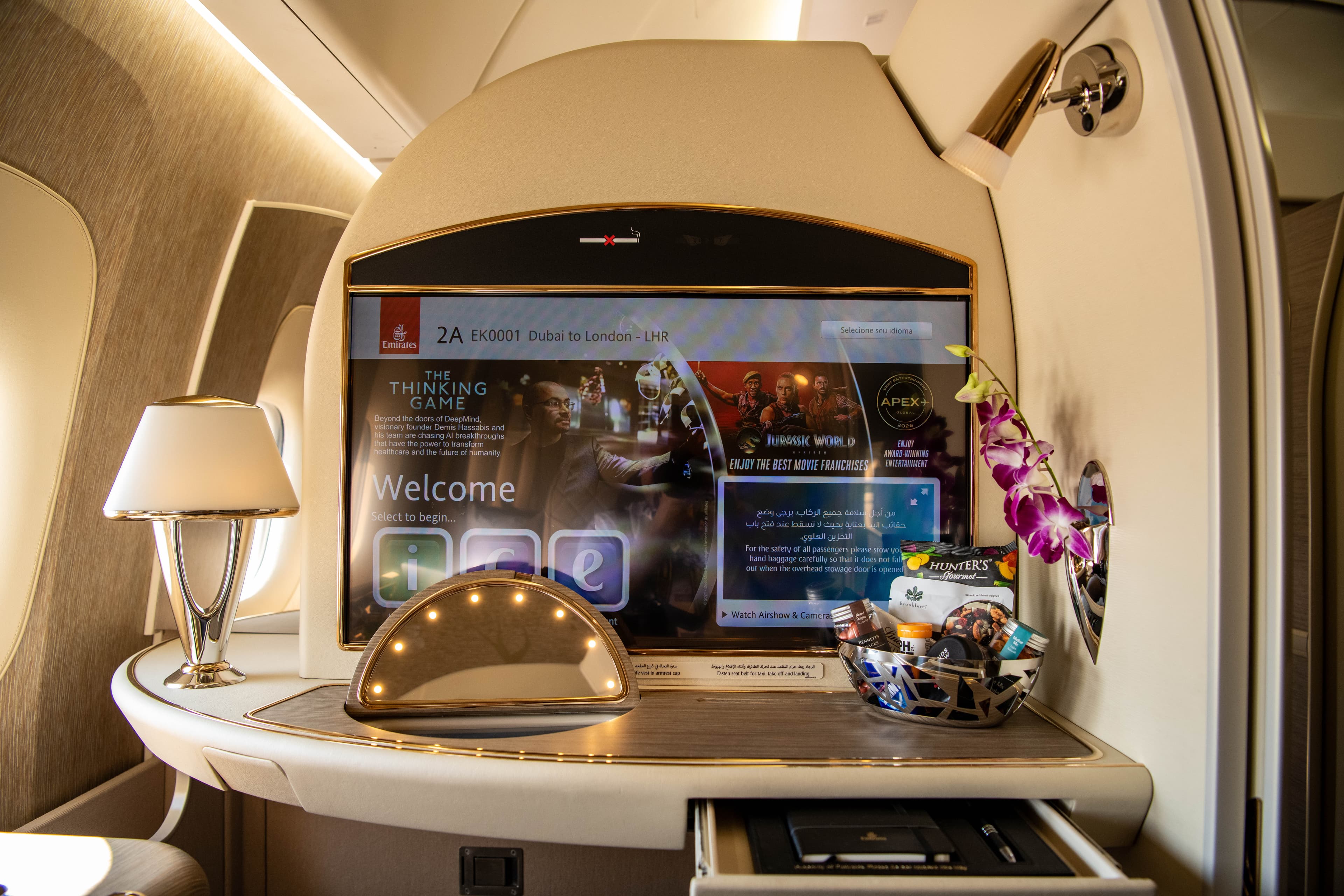 Emirates A380 First Class suite with ICE entertainment system offering 6500 channels on Dubai to London route