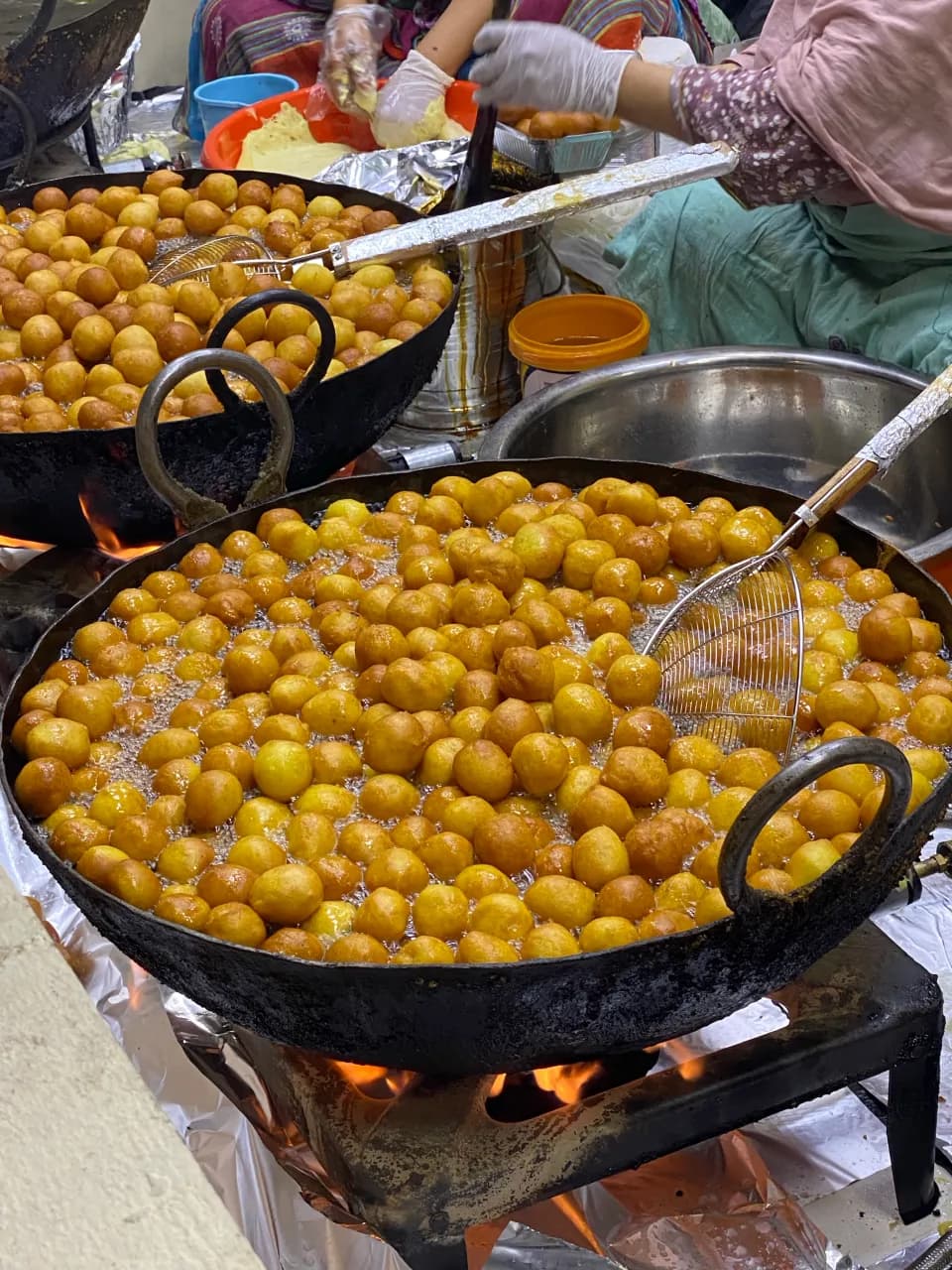 Freshly prepared traditional sweets, highlighting the diverse street food and international flavors at Global Village.